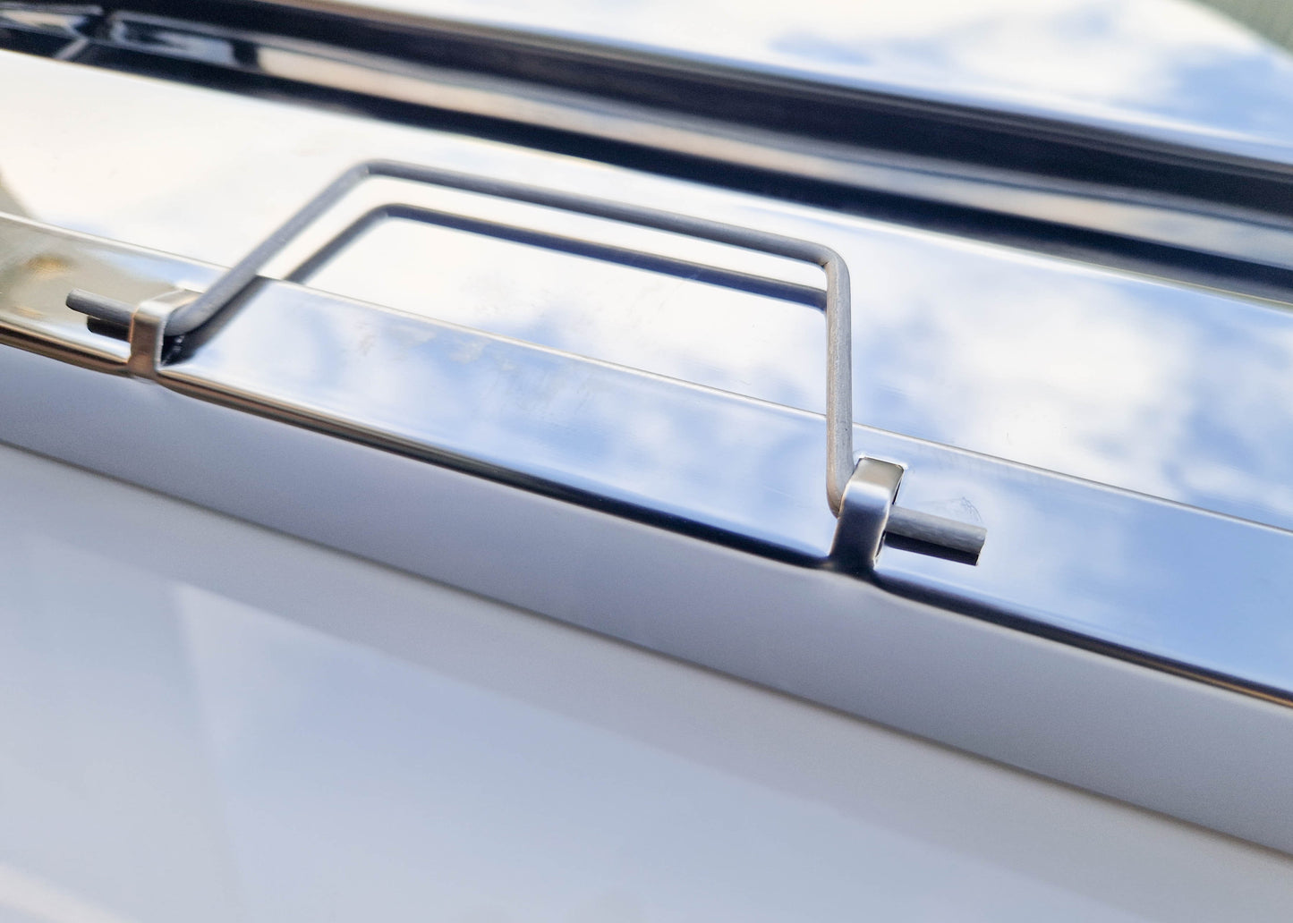 close up photo of the handle that is mounted on each side of the kitchen filter which helps with both fitting and removing when cleaning is required.