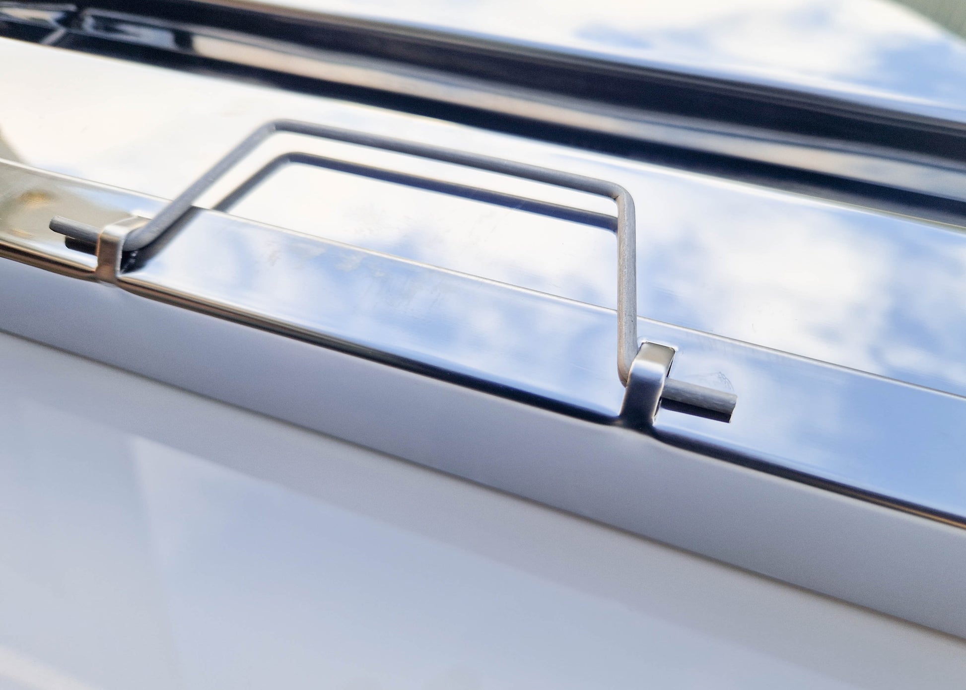 close up photo of the handle that is mounted on each side of the kitchen filter which helps with both fitting and removing when cleaning is required.