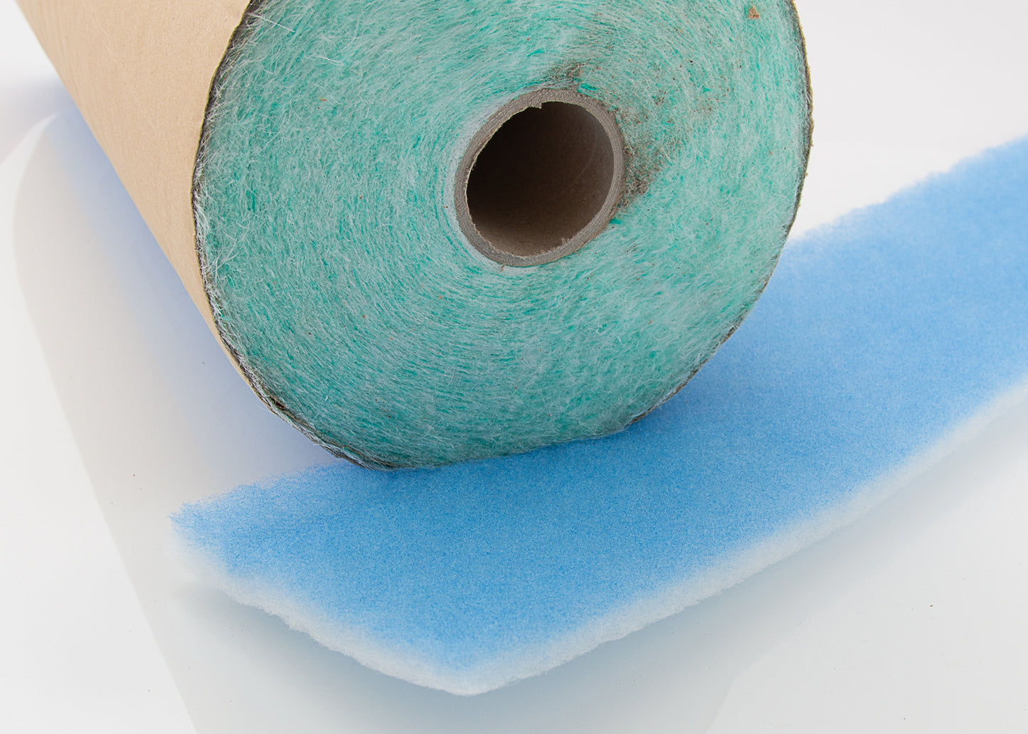Photo showing a roll of our Profibre paint stop together with the blue and white promedia filtration roll