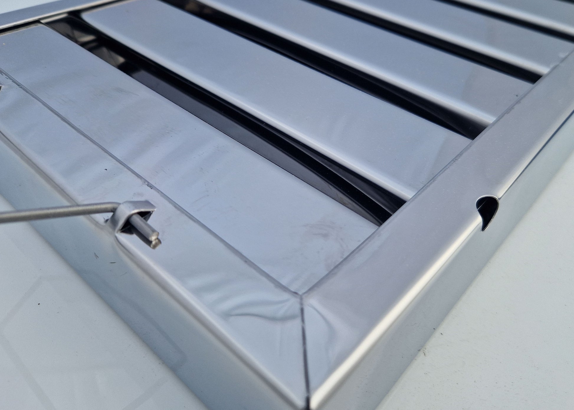 photo showing the corner, handle and drain hole for our steel cooker filters